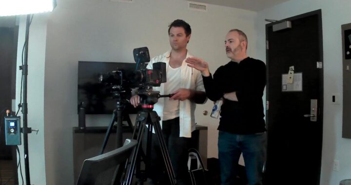Two filmmakers looking at camera viewfinders.